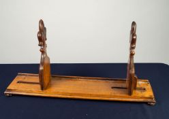 VICTORIAN CARVED OAK ?GOTHIC? ADJUSTABLE BOOKRACK, the sliding ends each of fleur de lys form, set