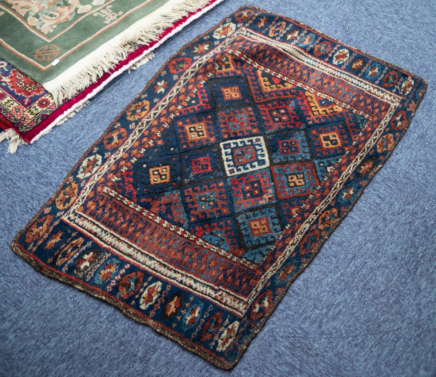 SHIRAZ RUG, with all-over diamond shaped tile pattern, the principal border white with repeat double