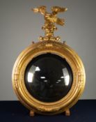 REGENCY STYLE CONVEX WALL MIRROR, circular with black reeded slip, the moulded frame with displaying