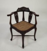 EARLY TWENTIETH CENTURY CARVED MAHOGANY CORNER CHAIR, of typical form with ribbon tied floral