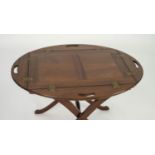 TWENTIETH CENTURY MAHOGANY BUTLER?S TRAY ON STAND, the tray of oval form with panelled centre and