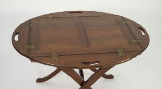 TWENTIETH CENTURY MAHOGANY BUTLER?S TRAY ON STAND, the tray of oval form with panelled centre and