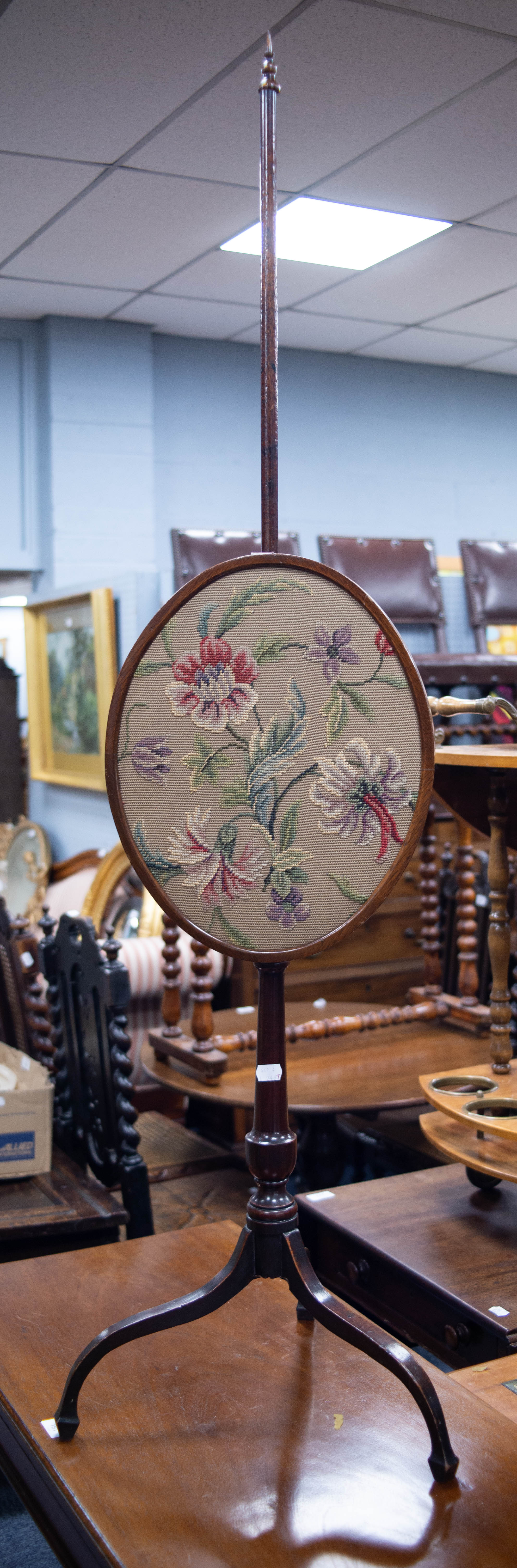 EARLY NINETEENTH CENTURY MAHOGANY AND STAINED FRUITWOOD POLE SCREEN, with adjustable oval panel