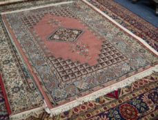 LIBRA CARPETS, CALCUTTA, MACHINE WOVEN RUG  with diamond shaped centre medallion and spandrels in