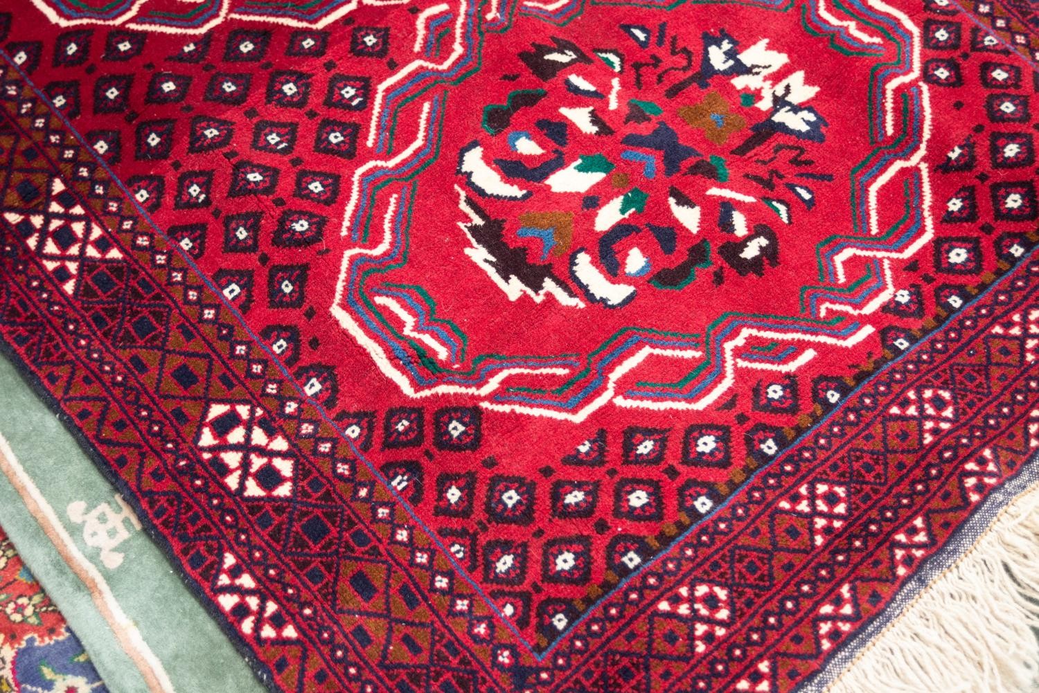 IRANIAN BALOUCHI HAND KNOTTED WOOL RUG, with tulip large medallion pattern on a wine red field - Image 2 of 2