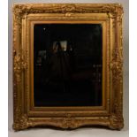 NINETEENTH CENTURY GILT GESSO ?PICTURE FRAME? WALL MIRROR, the later, oblong, bevel edged plate in a