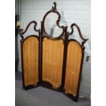 EARLY TWENTIETH CENTURY CARVED MAHOGANY THREE FOLD SCREEN, each section with a shaped bevel edge