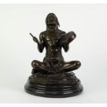 PATINATED BRONZE FIGURE OF A NATIVE NORTH AMERICAN INDIAN, modelled seated with drum and beater,