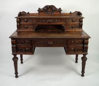 LATE NINETEENTH CENTURY CARVED OAK DESK, the oblong moulded top with sliding centre section, set