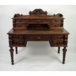 LATE NINETEENTH CENTURY CARVED OAK DESK, the oblong moulded top with sliding centre section, set