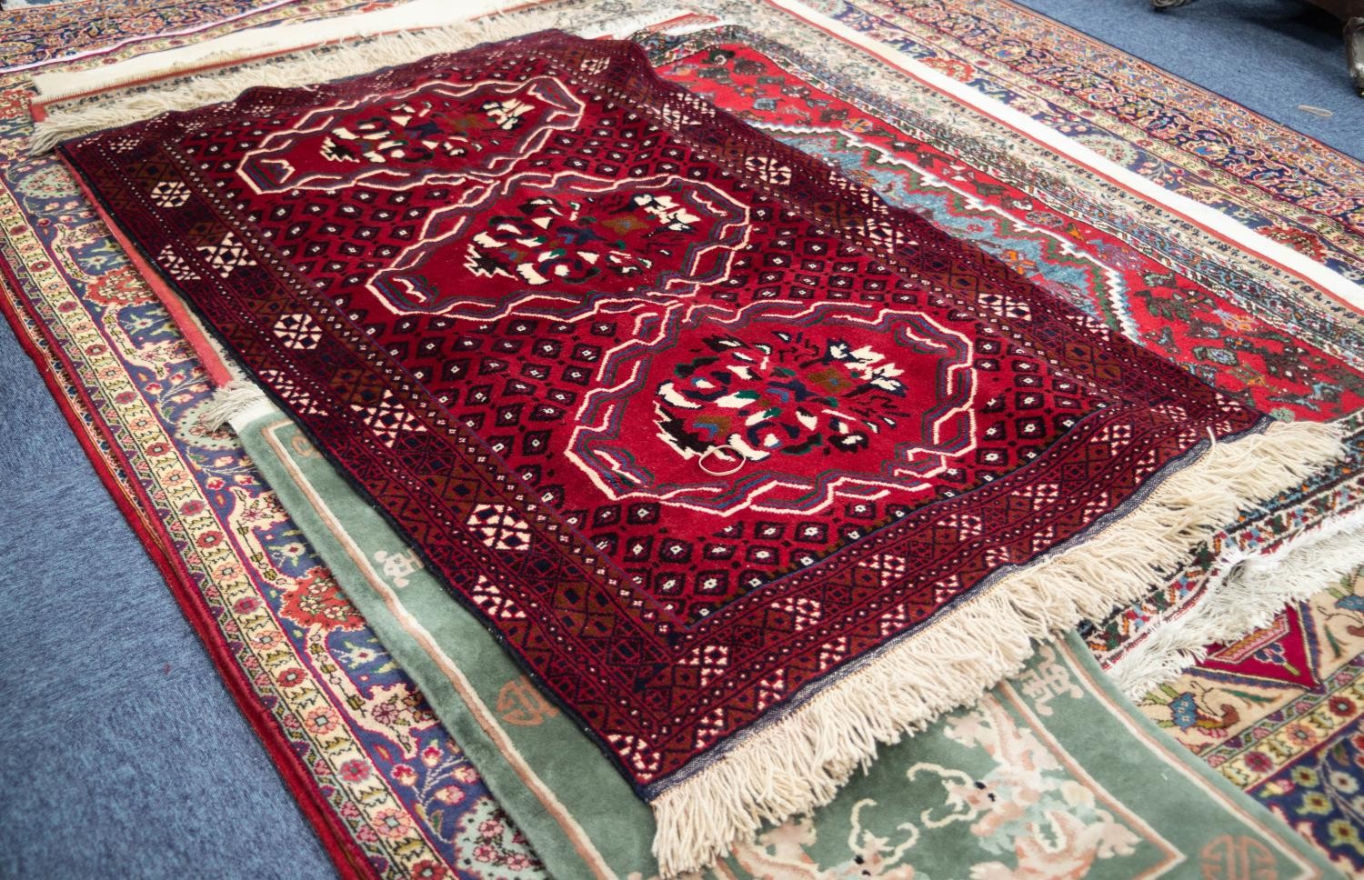 IRANIAN BALOUCHI HAND KNOTTED WOOL RUG, with tulip large medallion pattern on a wine red field