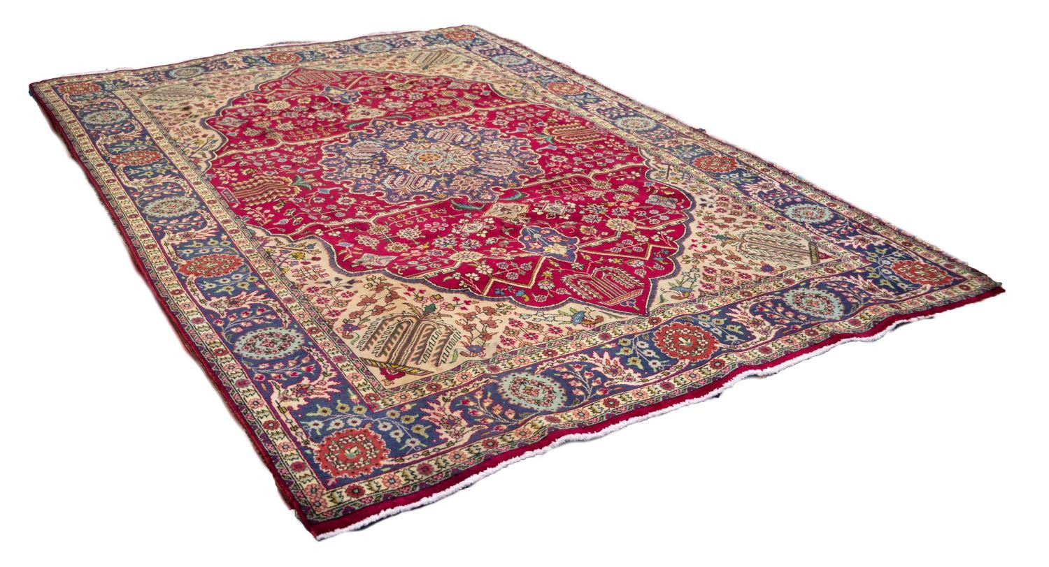 TABRIZ PERSIAN CARPET, with blue and floral shaped circular centre medallion with pendants on a