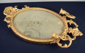 NINETEENTH CENTURY GILT GESSO GIRANDOLE, the oval, bevel edged plate in a moulded frame with shell