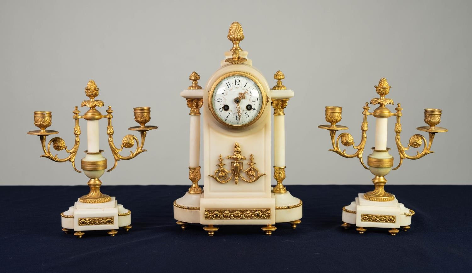 LATE NINETEENTH CENTURY FRENCH GILT METAL MOUNTED WHITE MARBLE THREE PIECE CLOCK GARNITURE, the