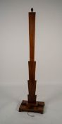 ART DECO FIGURED WALNUT STANDARD LAMP, the flat, fan shaped column, raised on a stepped, oblong