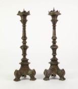 PAIR OF BRASS PRICKET CANDLESTICKS, each of panelled form with triform base and scroll feet,