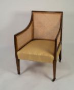 REGENCY MAHOGANY BERGERE ARMCHAIR, the moulded show wood frame enclosing a single caned back and