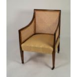 REGENCY MAHOGANY BERGERE ARMCHAIR, the moulded show wood frame enclosing a single caned back and