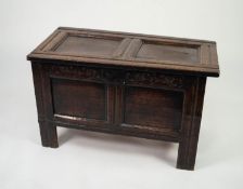 SEVENTEENTH CENTURY CRAVED OAK COFFER, the twin panelled top above a conforming front with steel