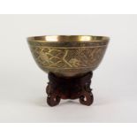 EARLY TWENTIETH CENTURY CHINESE ENGRAVED BRASS BOWL ON PIERCED HARDWOOD STAND, the bowl of steep