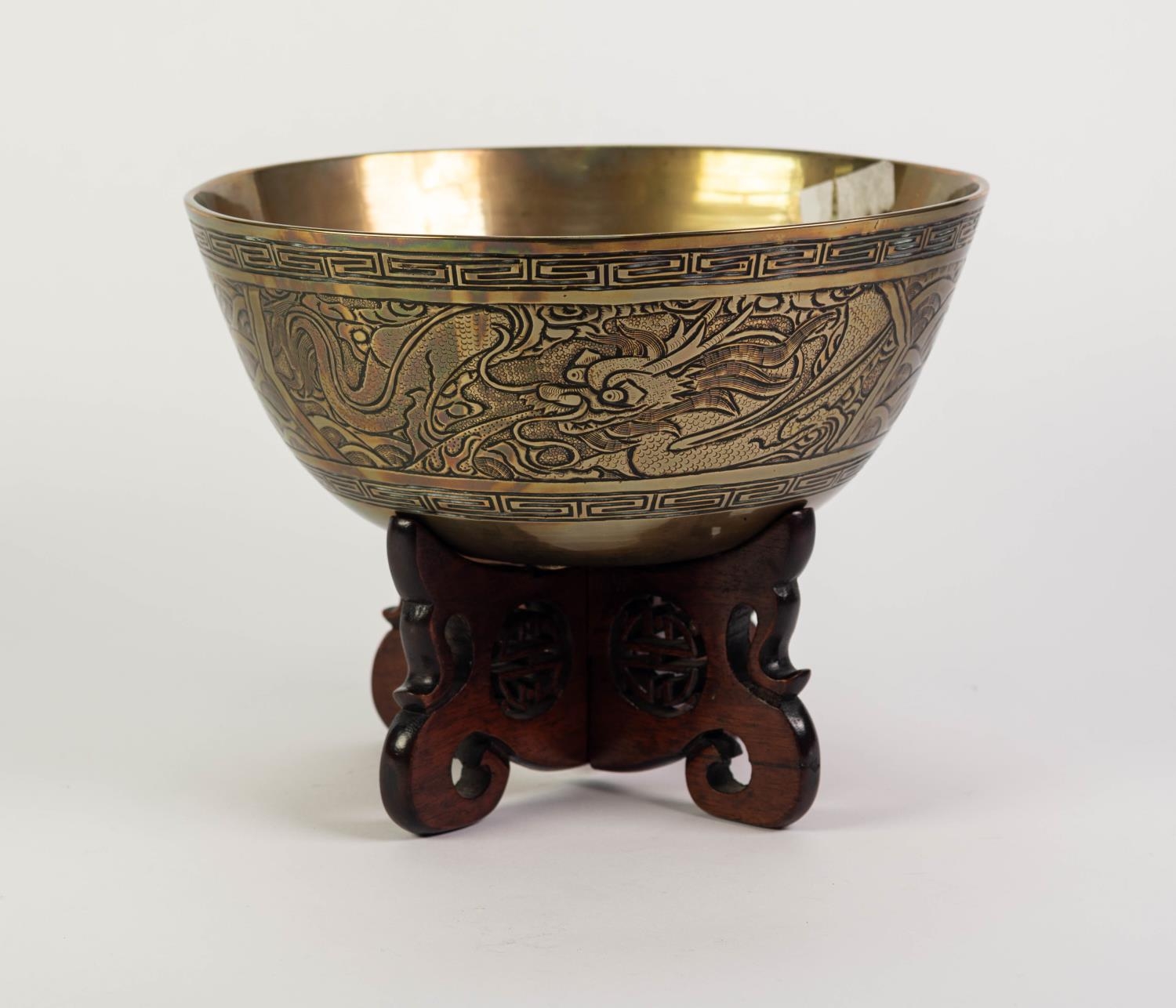 EARLY TWENTIETH CENTURY CHINESE ENGRAVED BRASS BOWL ON PIERCED HARDWOOD STAND, the bowl of steep - Image 2 of 4