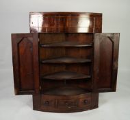 NINETEENTH CENTURY FIGURED MAHOGANY BOW FRONTED CORNER CUPBOARD, with flame cut twin panelled