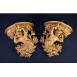 PAIR OF CARVED GILTWOOD ?MONKEY? WALL BRACKETS, each with shaped top above a monkey, crouching in