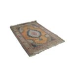 EASTERN RUG, with lozenge shaped centre medallion with pendants on plain salmon pink field