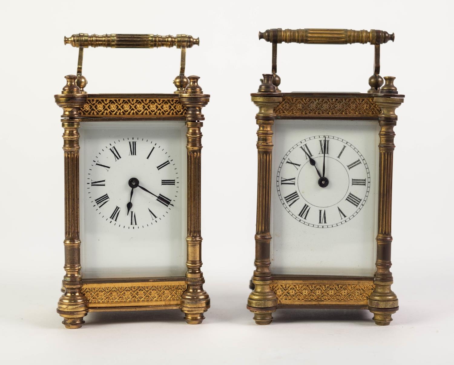 EARLY TWENTIETH CENTURY PAIR OF GILT BRASS CARRIAGE CLOCKS, each with white enamelled Roman dial,