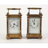EARLY TWENTIETH CENTURY PAIR OF GILT BRASS CARRIAGE CLOCKS, each with white enamelled Roman dial,