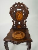 LATE NINETEENTH/ EARLY TWENTIETH CENTURY CONTINENTAL INLAID AND CARVED WALNUT HALL CHAIR, the