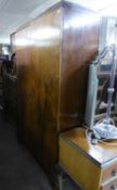 A 1930's COMPOSITE WALNUT PART BEDROOM SUITE VIZ A TWO-DOOR WARDROBE, DRESSING TABLE, A CABINET WITH