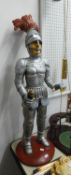 A RESIN FIGURE OF A KNIGHT IN ARMOUR