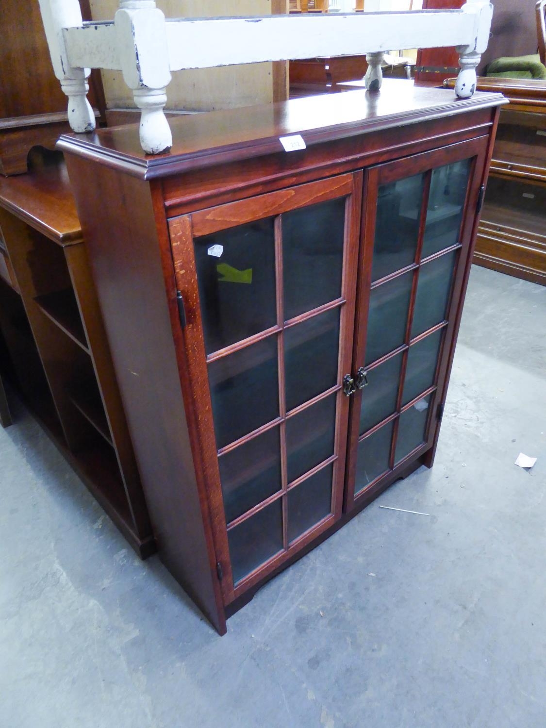 A REPRODUCTION SMALL BOOKCASE WITH TWO GLAZED DOORS