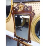 AN EARLY TWENTIETH CENTURY MAHOGANY PARCEL GILT GEORGIAN REVIVAL BEVELLED WALL MIRROR, 41" (104.2cm)