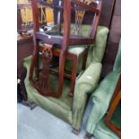 A GOOD QUALITY WINGED FIRESIDE ARMCHAIR, COVERED IN GREEN FABRIC AND RAISED ON LARGE CLAW AND BALL