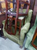 A GOOD QUALITY WINGED FIRESIDE ARMCHAIR, COVERED IN GREEN FABRIC AND RAISED ON LARGE CLAW AND BALL