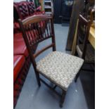 A SET OF FOUR OAK DINING CHAIRS, WITH SPINDLE BACKS, WITH FLORAL FABRIC COVERED SEATS,  RAISED ON