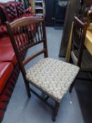 A SET OF FOUR OAK DINING CHAIRS, WITH SPINDLE BACKS, WITH FLORAL FABRIC COVERED SEATS,  RAISED ON