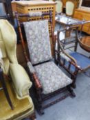 A HARDWOOD AMERICAN ROCKING ARMCHAIR, UPHOLSTERED IN FLORAL TAPESTRY