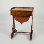 EARLY VICTORIAN FIGURED WALNUT LADY?S SEWING TABLE, the moulded oblong top with pierced gilt metal