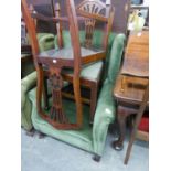 A GOOD QUALITY WINGED FIRESIDE ARMCHAIR, COVERED IN GREEN FABRIC AND RAISED ON STRAIGHT TAPERING