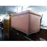 AN OTTOMAN BOX, UPHOLSTERED AND COVERED IN PINK AND GREY DIAPER PATTERN FABRIC