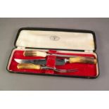 CASED THREE PIECE CARVING SET WITH HORN HANDLES, in red plush lined case marked for Latham & Owen