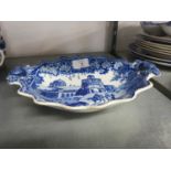 AN EARLY NINETEENTH CENTURY STAFFORDSHIRE BLUE AND WHITE TWO HANDLED OVAL DISH WITH BOUCHER AND