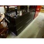 A BLACK GLOSS SIDEBOARD, OF CHEST OF TWO SHORT AND TWO LONG DRAWERS, SANS HANDLES, 4' 7" WIDE X 2'