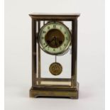 EARLY TWENTIETH CENTURY BRASS FOUR GLASS MANTLE CLOCK, of typical form with matted centre to the