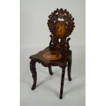 LATE NINETEENTH/ EARLY TWENTIETH CENTURY CONTINENTAL INLAID AND CARVED WALNUT HALL CHAIR, the