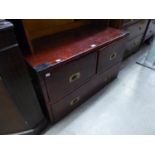 A MILITARY STYLE STAINED PITCH PINE LOW CHEST OF TWO SHORT AND TWO LONG DRAWERS WITH BRASS