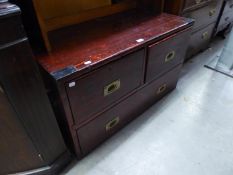 A MILITARY STYLE STAINED PITCH PINE LOW CHEST OF TWO SHORT AND TWO LONG DRAWERS WITH BRASS